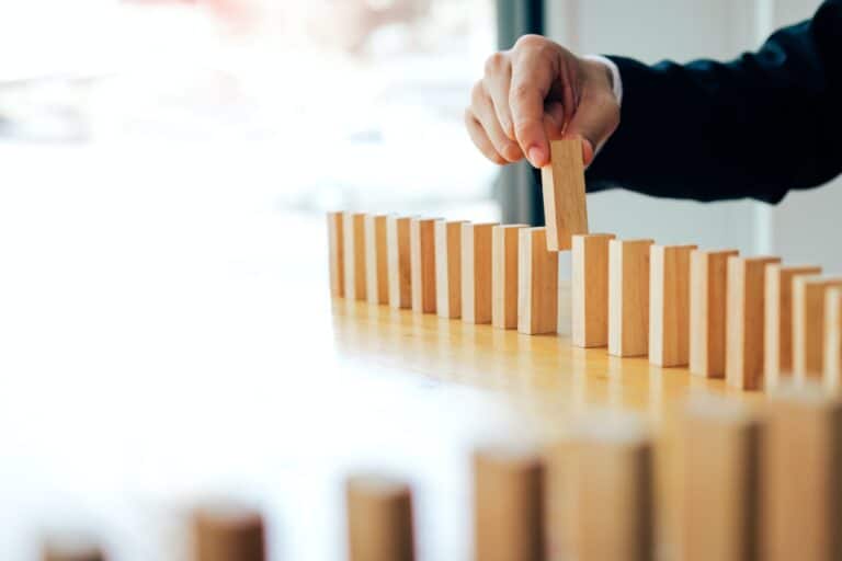 Businessman hand pick one of wood block in row with leadership concept