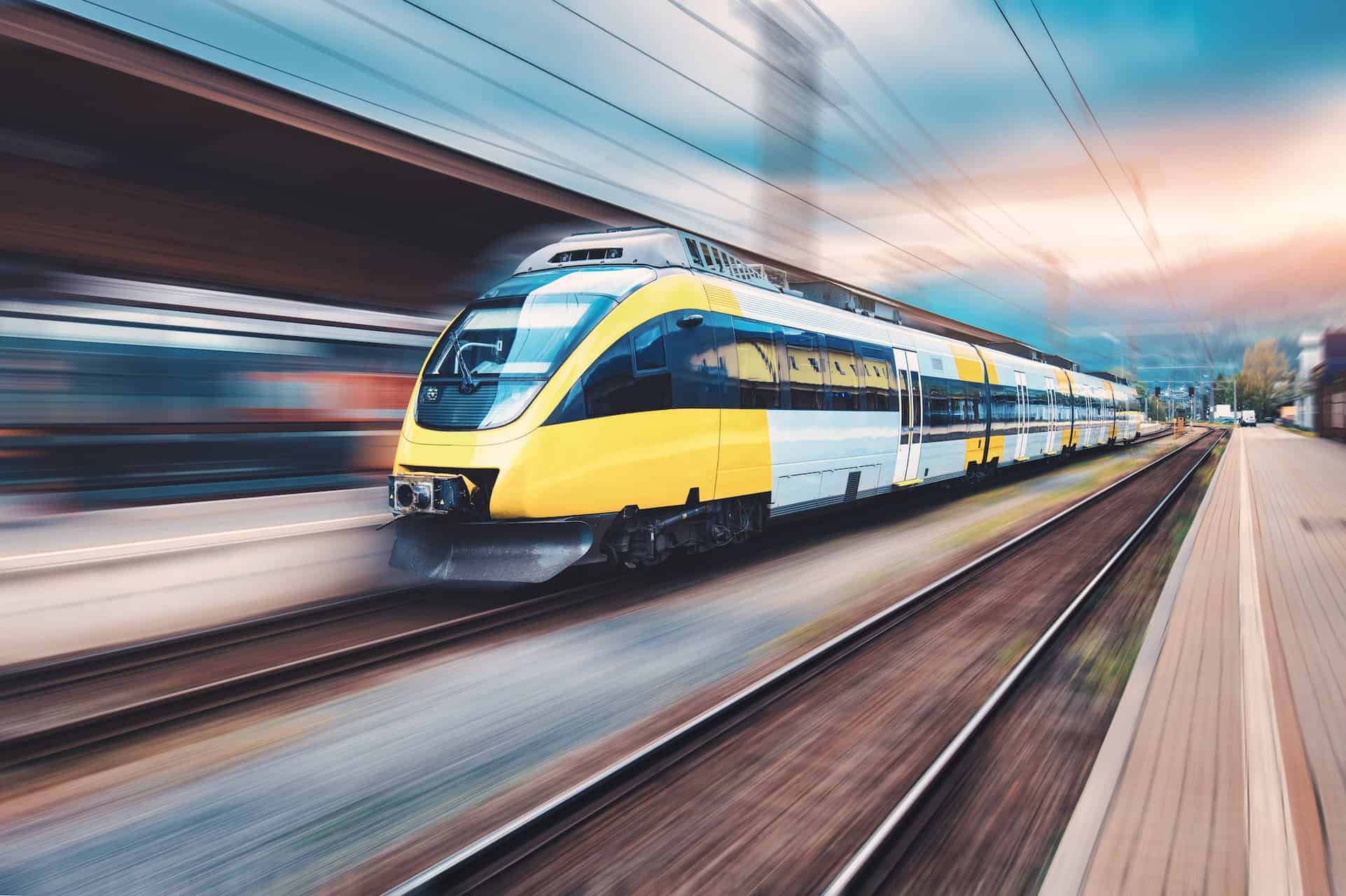 High speed yellow train in motion on the railway station